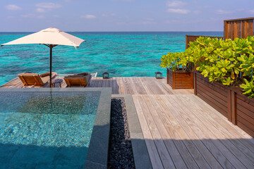 Luxurious exterior of a very expensive rich water villa in the Maldives, decorated with natural wood.