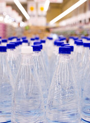 water bottles with blue caps in supermarket