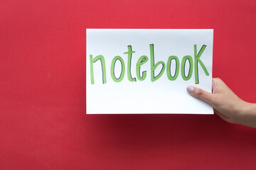 Woman's hand holding a sign