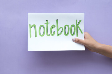 Woman's hand holding a sign