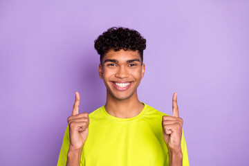 Photo of young black man happy positive smile indicate finger empty space ad promo select isolated over purple color background