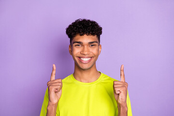 Photo of young black man happy positive smile indicate finger empty space ad promo select isolated...