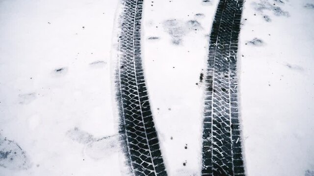 Bike wheel tracks on snow covered steps, Kent, UK