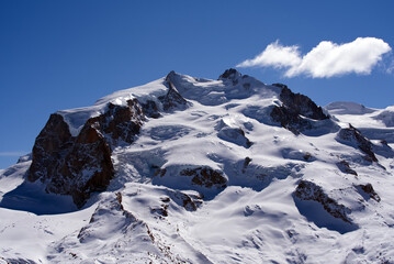 Fototapeta na wymiar Snow capped mountains, snowfields and glaciers at Zermatt, Switzerland, seen from Gornergrat railway station. Photo taken March 23rd, 2021.