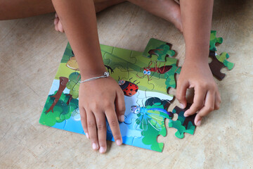 little girl playing with puzzle, education.