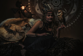 beautiful shamanic woman with owl in the interiors.