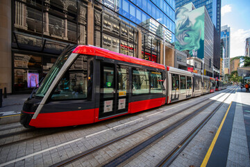 Tram moving through George St in Sydney NSW Australia