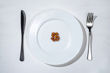 Healthy food concept: peanuts on a plate.