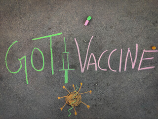 The inscription text on the grey board, Got Vaccine with hand drawn cornavirus and injection. Using...