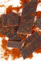 Beef jerky with hot pepper isolated on white background. Dried meat.
