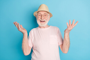 Photo of elderly man pensioner happy positive smile excited wear sunhat isolated over blue color...
