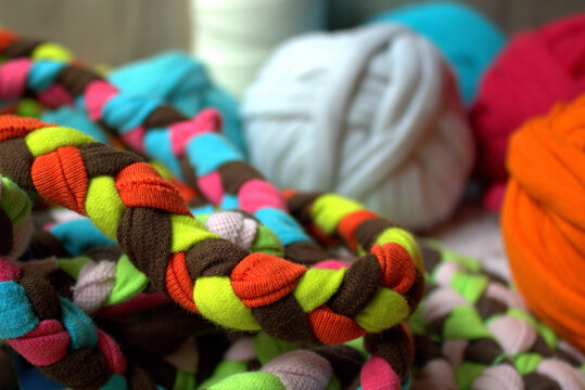 T-shirt Jump Rope. Old t-shirts become tug toys.Colorful handmade dog toys made from braided recycled fabric strips. Eco-friendly pet accessories created through upcycling and textile recycling. 