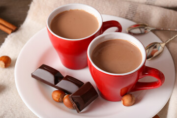Two cups with a fragrant drink and sweets close-up