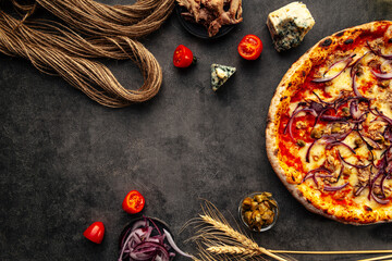 Fresh baked onion pizza on the decorated grey background