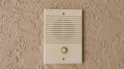 Ringing doorbell with thumb. Closeup of male hand pushing home intercom door bell button.