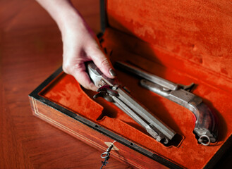 hand taking old pistol