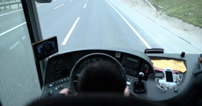 selective focus of a highway road and out of focus bus driver and his perspective in a bus traveling in motion from high angle