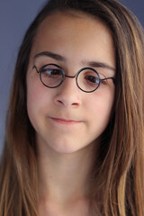 Fototapeta premium Cute young, brunette girl with funny eyeglasses