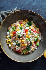 Rice salad with tuna and vegetables. Top view with copy space. Healthy food.