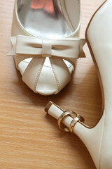 Beautiful wedding ring on the bride's white shoes
