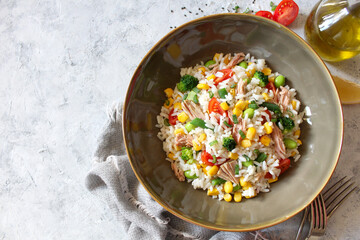 Rice salad with tuna and vegetables. Top view with copy space. Healthy food.