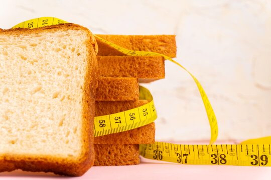 Premium Photo  Weight scale with wholesome slice of bread and measuring  tape on white background