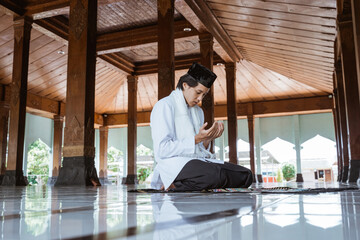 Muslim man kneel down worship and prays for Allah in the mosque