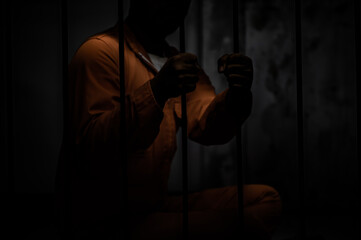 Asian man desperate at the iron prison,prisoner concept,thailand people,Hope to be free,Serious...