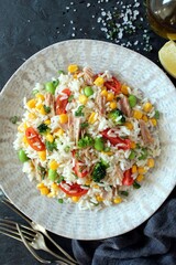 Rice salad with tuna and vegetables. Top view with copy space. Healthy food.