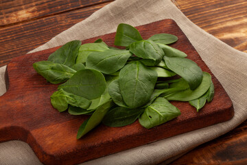 Fresh green spinach on the wooden board