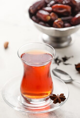 Glass of tasty Turkish tea on light background