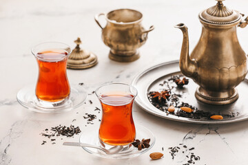 Glasses of tasty Turkish tea on light background