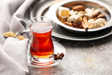 Glass of tasty Turkish tea on grey background