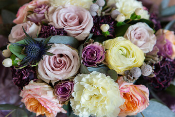 Beautiful bouquet of vintage flowers. Roses, carnationon and leaves on dark background.