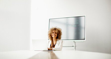 African American businesswoman sitting and working on laptop in the modern office