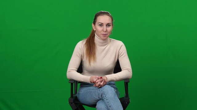 Professional young woman interviewing applicant actor, waving goodbye and making facepalm gesture. Portrait of Caucasian casting director shocked with skills of artist. Green screen.