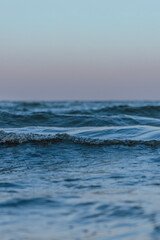 small sea waves in the sea on a clear warm day. Summer vacation near the water