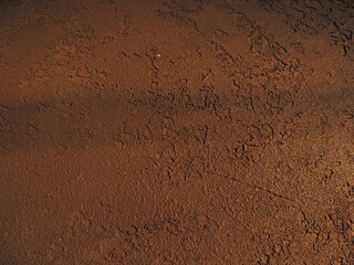 Textured background with shadows and light from the sun. Dark background. Desktop background. Black, gray, and yellow. Venetian plaster.