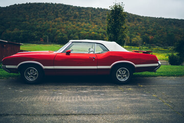 Retro red vintage American car on asphalt road
