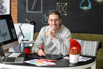 Young male designer working in office