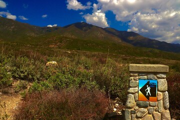 Beautiful Hiking Trail On a Sunny Day with Mountains and Clouds