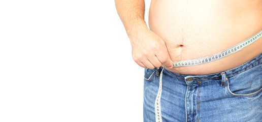 Naklejka premium Fat man with big stomach wearing jeans holding measuring tape isolated on white
