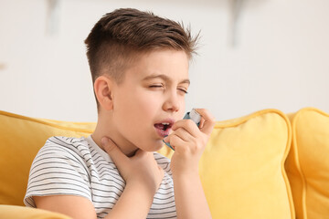 Little boy with inhaler having asthma attack at home