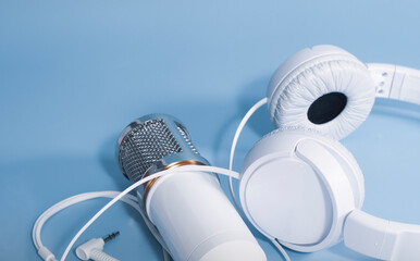 Microphone and headphones for sound recording on a blue background