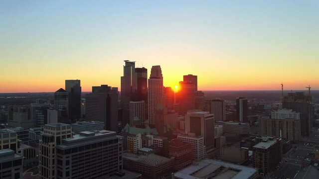 sun setting down behind buildings in minneapolis downtown aerial footage, explore Minnesota cityscapes meet minneapolis, msp