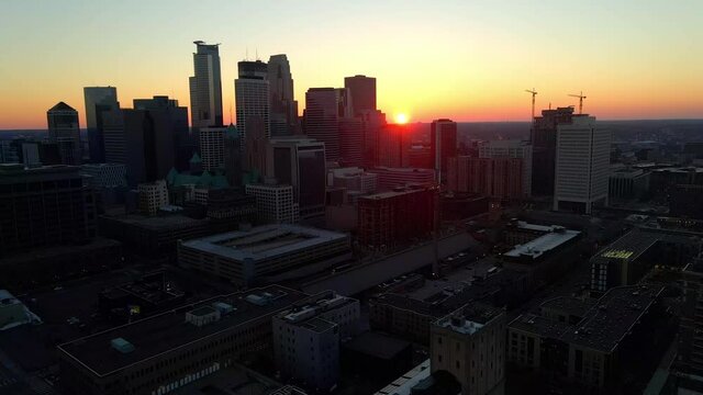 beautiful cityscapes sun setting behind downtown Minneapolis skyline aerial footage