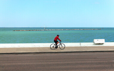 Man on a bike at the bay