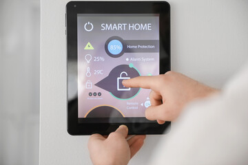 Man using smart home security system control panel, closeup