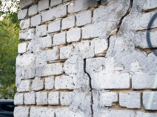 Brick wall with a crack and traces of repair