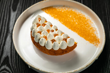 dessert with bize and orange jam on a white plate
